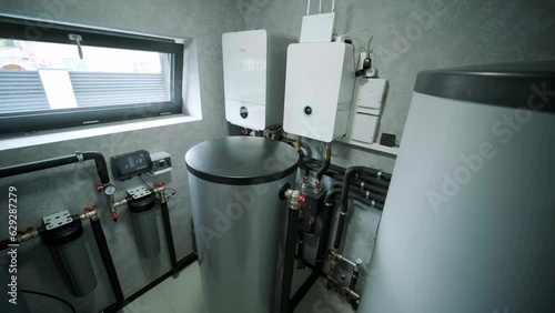House boiler room interior with modern water heating system
