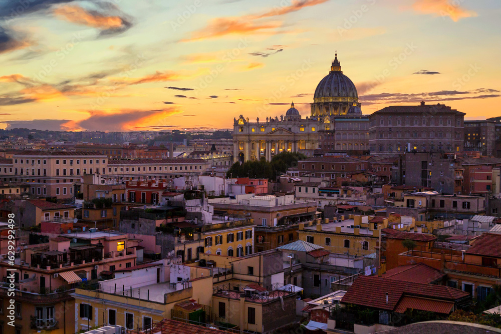 Cityscape view of Rome at sunset with St Peter Cathedral in Vatican.