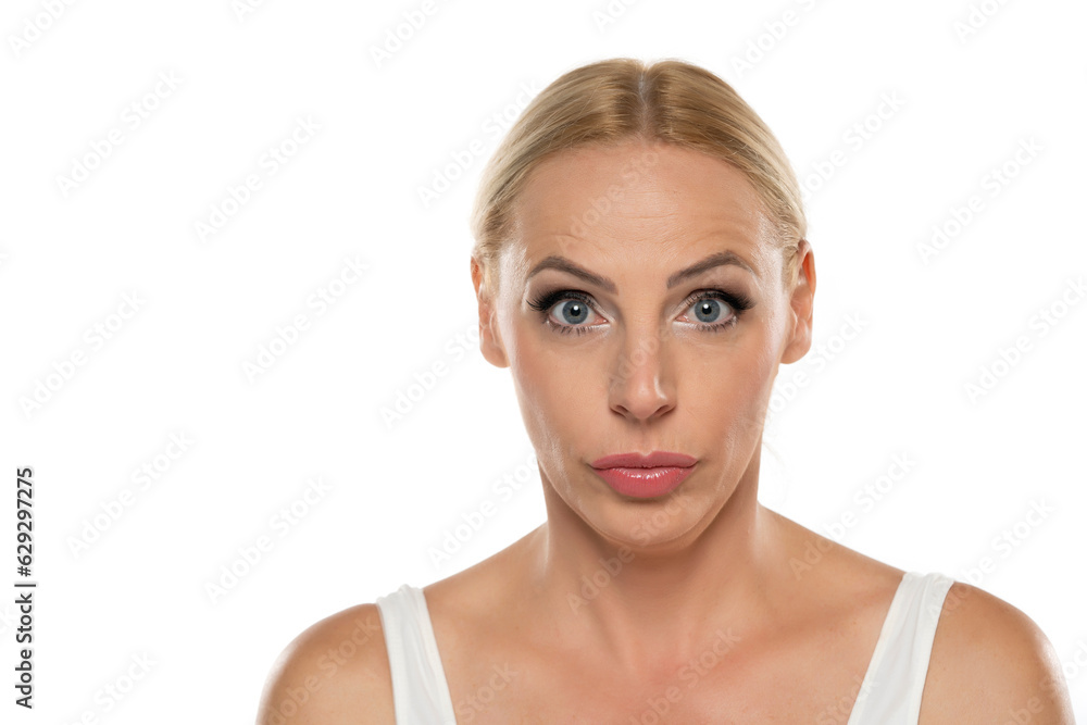 Portrait of senior middle aged surprised blond woman with makeup on white background Portrait of senior middle aged surprised blond woman with makeup on white background