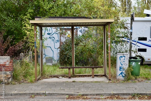 Empty bus stop with broken glass on a deserted street