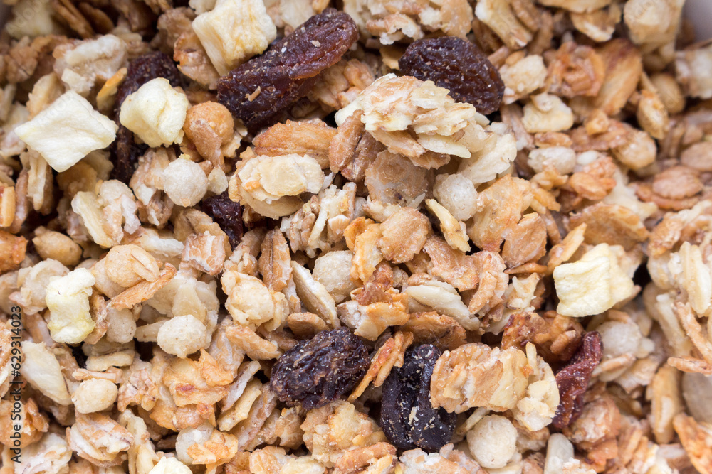 baked muesli with raisins and apples background, close-up. baked muesli with raisins and apples background, close-up.