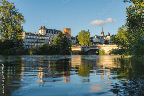 View of the Castle of Pau, the XIV juillet bridge and the gave de Pau at sunset, with reflection on the water