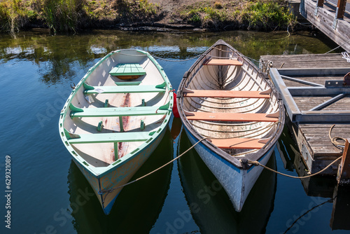 Historic wooden row boats moored at a dock on a summer day.  Shot in Seatle Washington on the waterfornt. photo