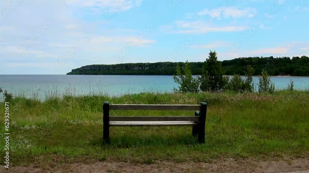 Lonely bench on the evening shore of Lake Huron Lonely bench on the evening shore of Lake Huron