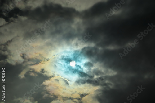 Clouds covering the sun during the day. Dramatic sun scene