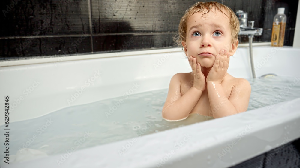 Little baby boy rubbing eyes after splashing water in bath. Child hygiene, fun, playing at home. Little baby boy rubbing eyes after splashing water in bath. Child hygiene, fun, playing at home.