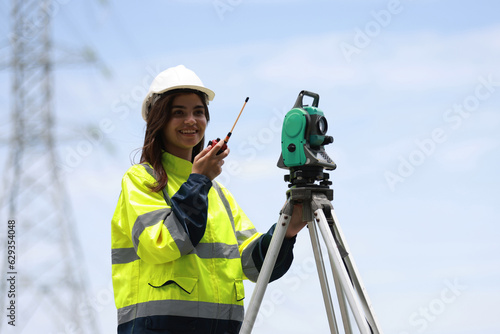 female survey engineer work with survey camera and walkie talkie