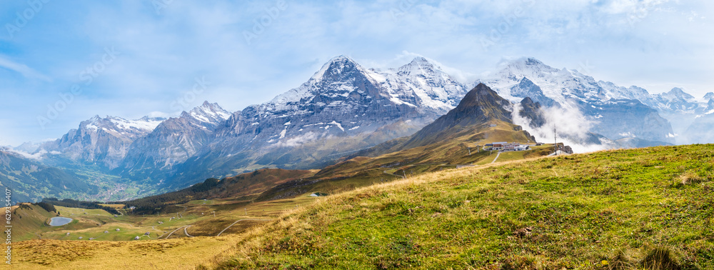 Autumn in Swiss Alps. Panorama of mountain range with peaks Eiger, Wetterhorn, Schreckhorn, Monch, Jungfraujoch and Jungfrau from top of Mannlichen near Wengen and Lauterbrunnen, Switzerland