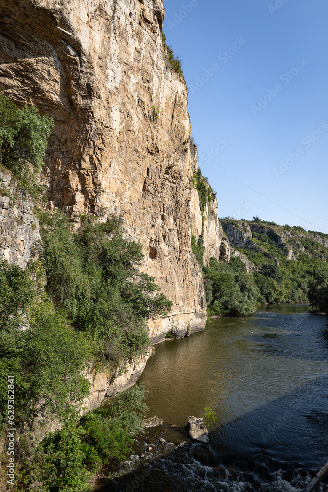 Steep rock formations on the banks of Iskar river gorge in Bulgarian balkan mountains.