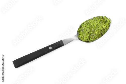 Spoon with delicious pesto sauce isolated on white, top view