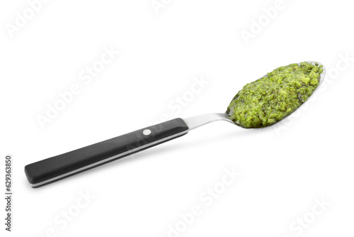Spoon with delicious pesto sauce isolated on white