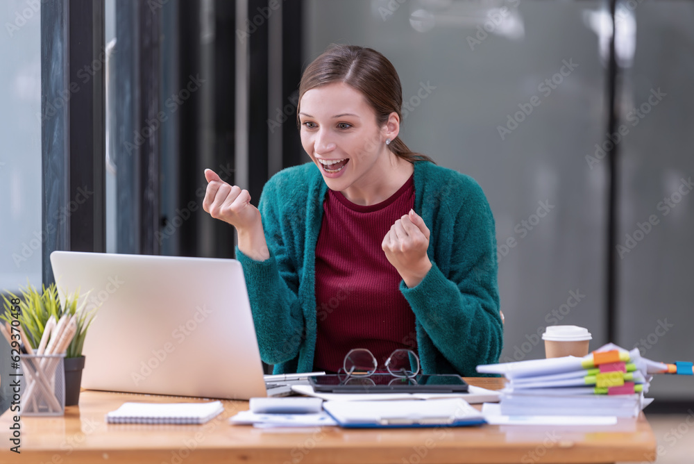 Happy businesswoman laughing with joy at the good news about work at the workplace, gladly looking at laptop screen, feeling excited. Happy businesswoman laughing with joy at the good news about work at the workplace, gladly looking at laptop screen, feeling excited.