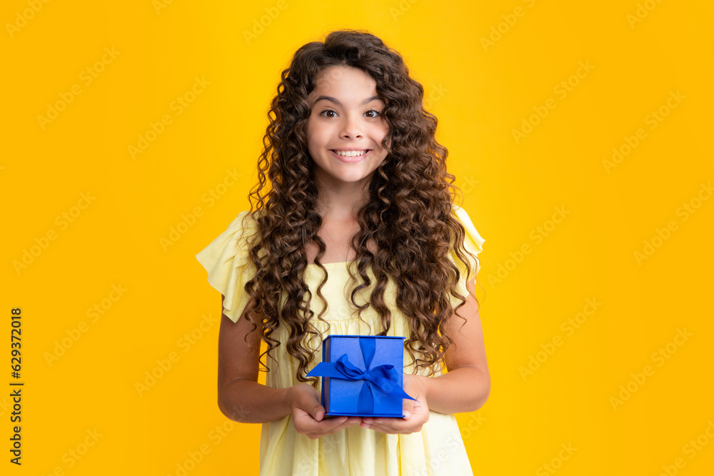 Happy teenager portrait. Child teen girl 12-14 years old with gift on isolated background. Birthday, holiday concept. Teenager hold present box. Smiling girl. Happy teenager portrait. Child teen girl 12-14 years old with gift on isolated background. Birthday, holiday concept. Teenager hold present box. Smiling girl.