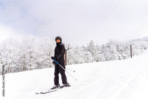 Young Asian man athlete practice downhill sliding skiing on snow mountain at ski resort. Handsome guy enjoy outdoor active lifestyle travel nature and winter extreme sport training on holiday vacation © CandyRetriever 