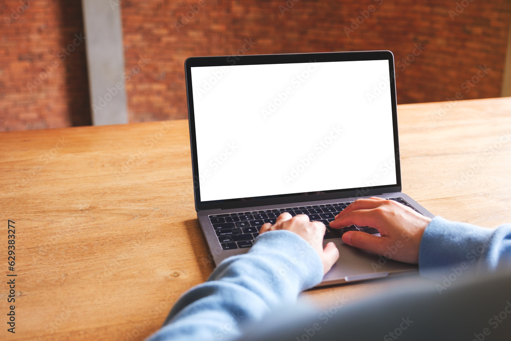 Mockup image of a woman using and typing on laptop computer with blank white desktop screen Mockup image of a woman using and typing on laptop computer with blank white desktop screen
