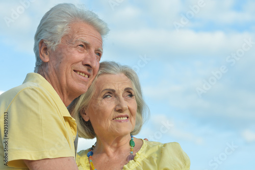 Beautiful Caucasian aged couple outdoors on a sky background © aletia2011