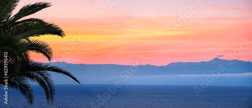 Fototapeta Naklejka Na Ścianę i Meble -  Banner of sunset over sea in Corfu island in Greece. Summer time and mood. Beautiful vibrant evening. Copy space.