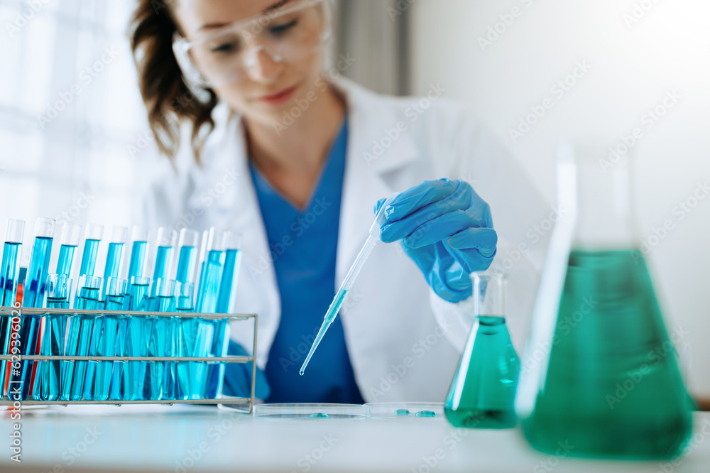 Modern medical research laboratory. female scientist working with micro pipettes analyzing biochemical samples, advanced science chemical laboratory for medicine.