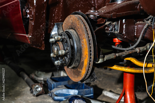 Close up car wheel take to piece to do car maintenance in auto repair garage