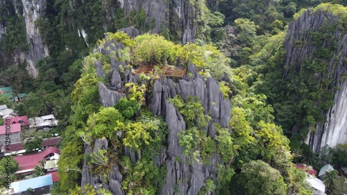 Canopy walk and dream catcher viewpoint, also called Taraw cliff on top of lush tropical jagged rock formation in El Nido town. Aerial photo