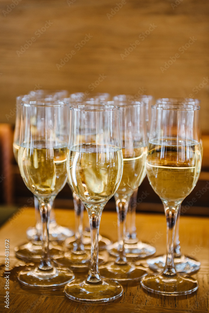 Champagne. Many glass of white wine. Glasses of champagne on table bar. Buffet. Celebration of birthday, baptism, wedding, corporate party. Catering service. Serves glasses of sparkling wine. Closeup Champagne. Many glass of white wine. Glasses of champagne on table bar. Buffet. Celebration of birthday, baptism, wedding, corporate party. Catering service. Serves glasses of sparkling wine. Closeup