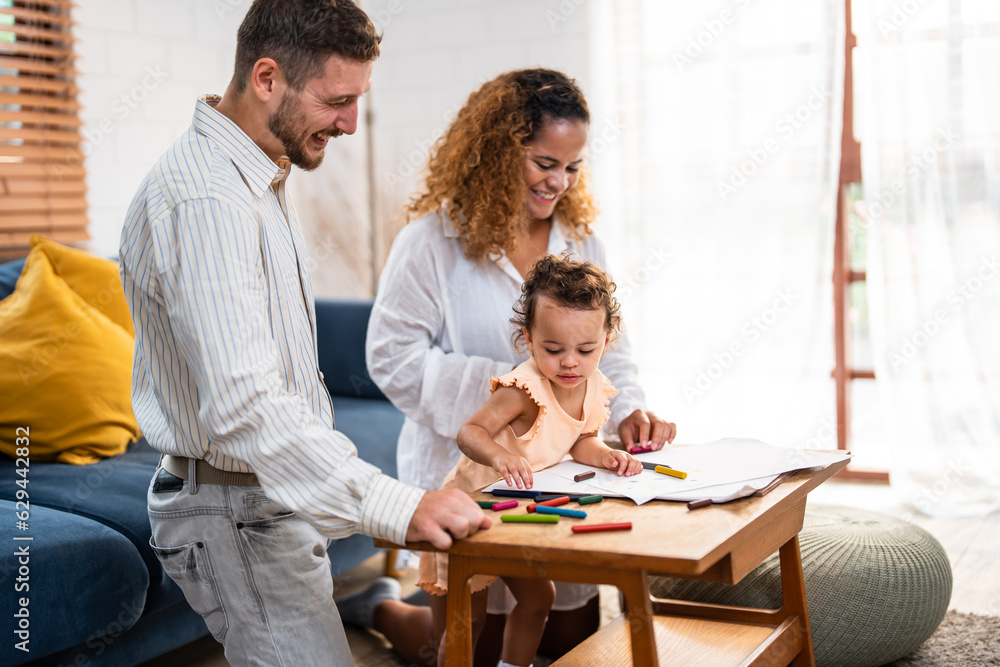 Caucasian family painting on paper with parents indoors in house. Caucasian family painting on paper with parents indoors in house.