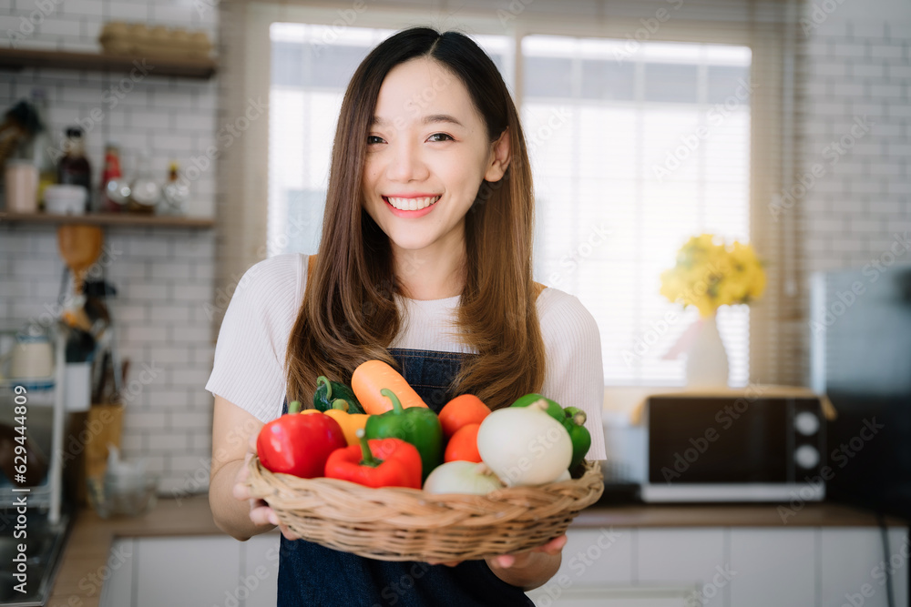 Woman is cooking in home kitchen. Female hands cut bell pepper, vegetables, greens, tomatoes on table on wooden boards. Healthy food, salad or vegetarian food. Woman is cooking in home kitchen. Female hands cut bell pepper, vegetables, greens, tomatoes on table on wooden boards. Healthy food, salad or vegetarian food.