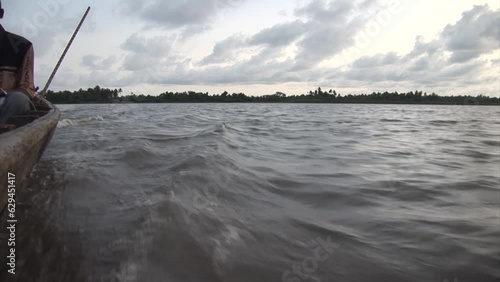Riding fast on a pirogue in Africa. Nigeria, Badagry lagoon. photo