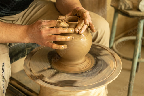 man making the top part of the pot