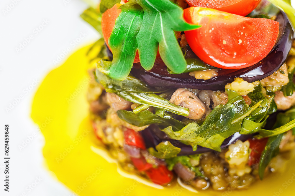 A fresh and vibrant salad with a variety of produce on the plate, including arugula, tomatoes, fruit and vegetables for healthful eating and wellbeing. A fresh and vibrant salad with a variety of produce on the plate, including arugula, tomatoes, fruit and vegetables for healthful eating and wellbeing.