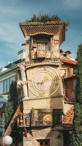 Tbilisi, Georgia. People Walking Near Famous Rezo Gabriadze Marionette Theater Clock Tower On Old City. Vertical Footage Video. Puppet Theater Museum In Tbilisi, Georgia, Caucasus. photo