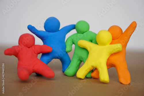 Colorful plasticine people. Human figures from plasticine sculpture. Concept, friendships, partnerships and relationships between people. Sculting enhance imagination.              photo