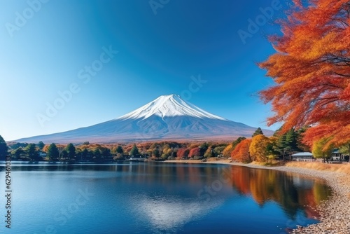 Vulcano mountain with a colorful tree in the foreground and beautiful clear mountain lake, Japan nature. © annamaria
