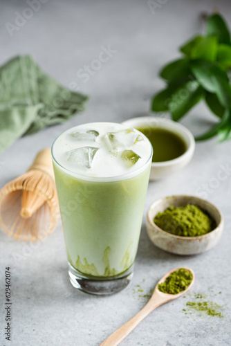 Ice Matcha Latte Green Tea In Glass Cup On Grey Concrete Background. Healthy Refreshing Summer Drink