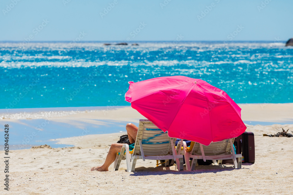 Lounger chairs and parasol umbrellas on sandy beach in Cape Town Lounger chairs and parasol umbrellas on sandy beach in Cape Town