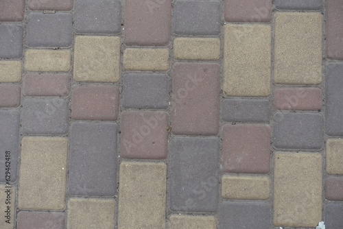 Top view of dusty brown  yellow and pink colored concrete pavers