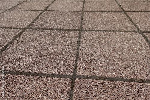 Bilde på lerret Coarse surface of pavement made of pink tiles of resin bound gravel