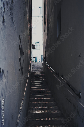 A small street with old stairs of Alfama, Lisbon, in the evening light. © Øyvind