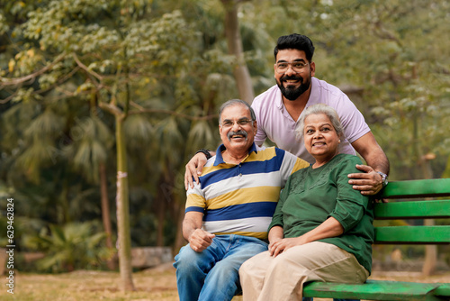Young Indian man with his parents at park © Niks Ads