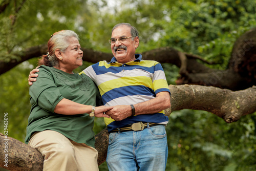 happy Indian senior couple together spending time at park.