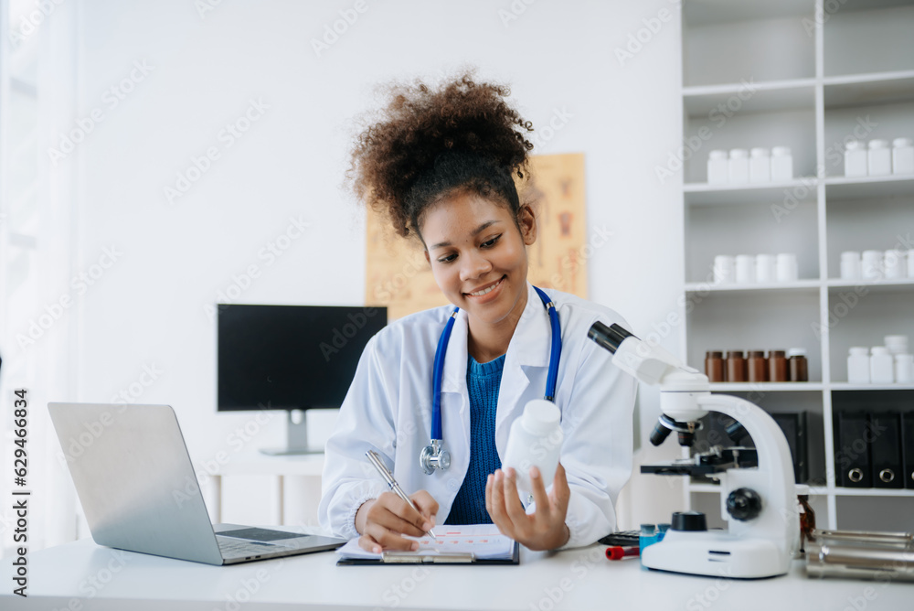 .Young scientists conducting research investigations in a medical laboratory, a researcher in the foreground is using a microscope in laboratory for medicine. .Young scientists conducting research investigations in a medical laboratory, a researcher in the foreground is using a microscope in laboratory for medicine.