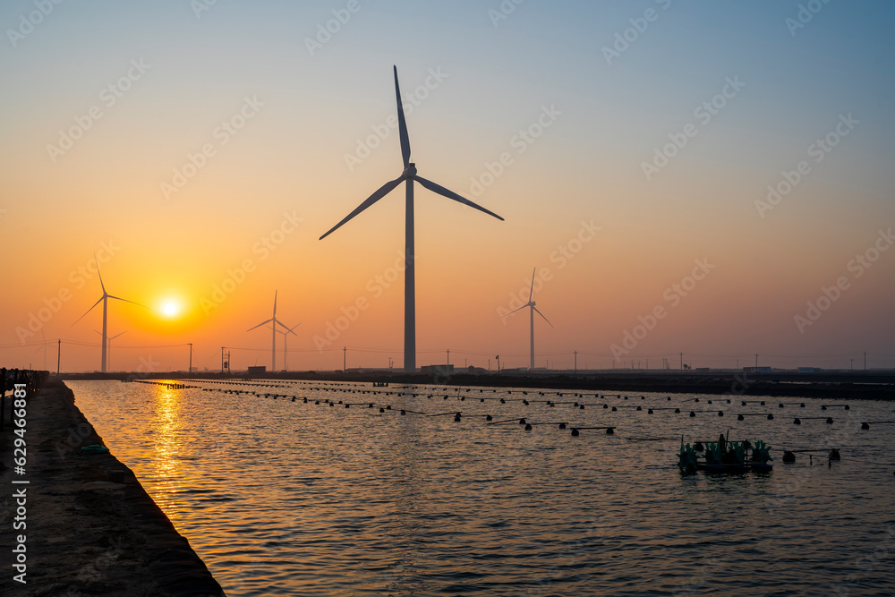 Seaside wind power and sea cucumber farms in the morning Seaside wind power and sea cucumber farms in the morning