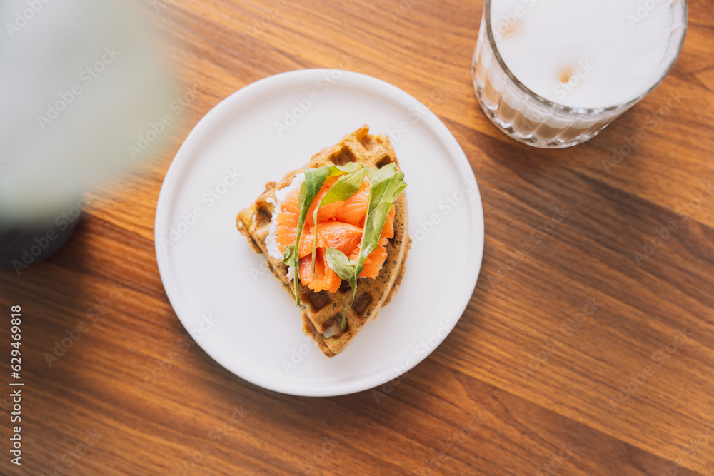Toast with cheese and red fish on a white plate with coffee. Toast with cheese and red fish on a white plate with coffee.