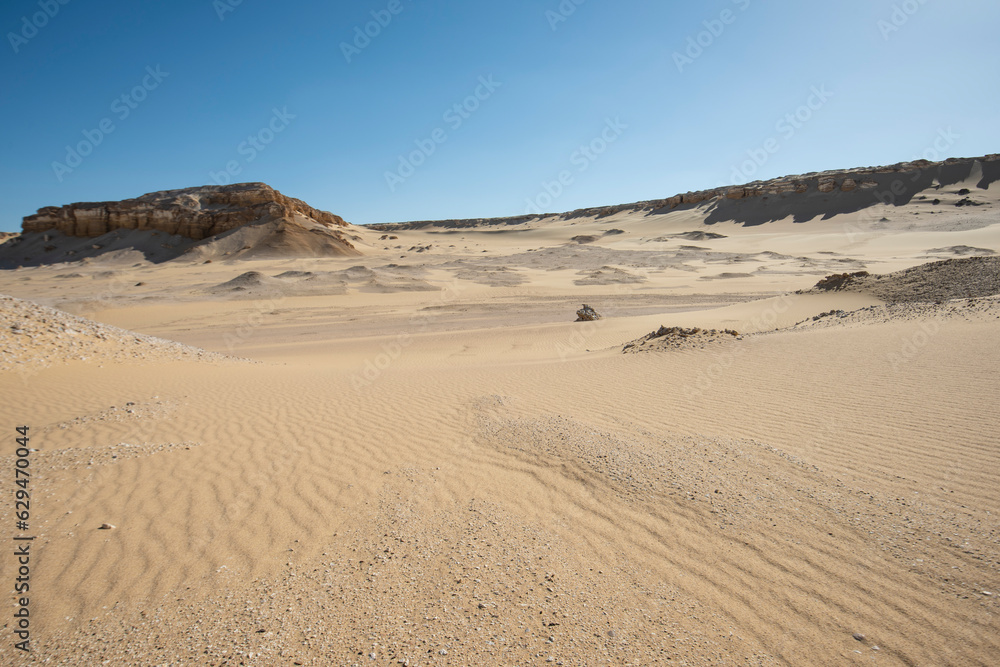 Barren desert landscape in hot climate with mountain rock formation Barren desert landscape in hot climate with mountain rock formation