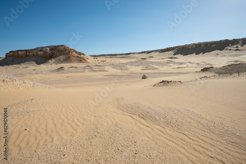 Barren desert landscape in hot climate with mountain rock formation