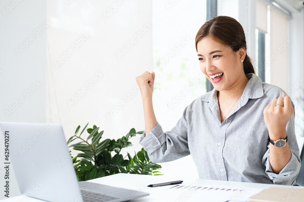Asian girl celebrate with mobile phone and laptop, success happy pose. E-commerce, university education, internet technology, or startup small business concept. Modern office with copy space Asian girl celebrate with mobile phone and laptop, success happy pose. E-commerce, university education, internet technology, or startup small business concept. Modern office with copy space