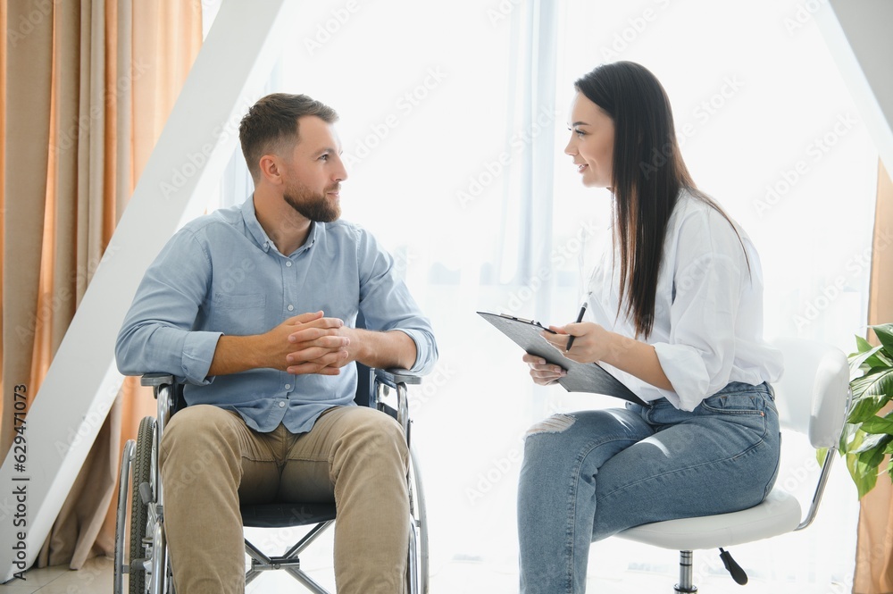 Young bearded man on wheelchair during home psychotherapy Young bearded man on wheelchair during home psychotherapy