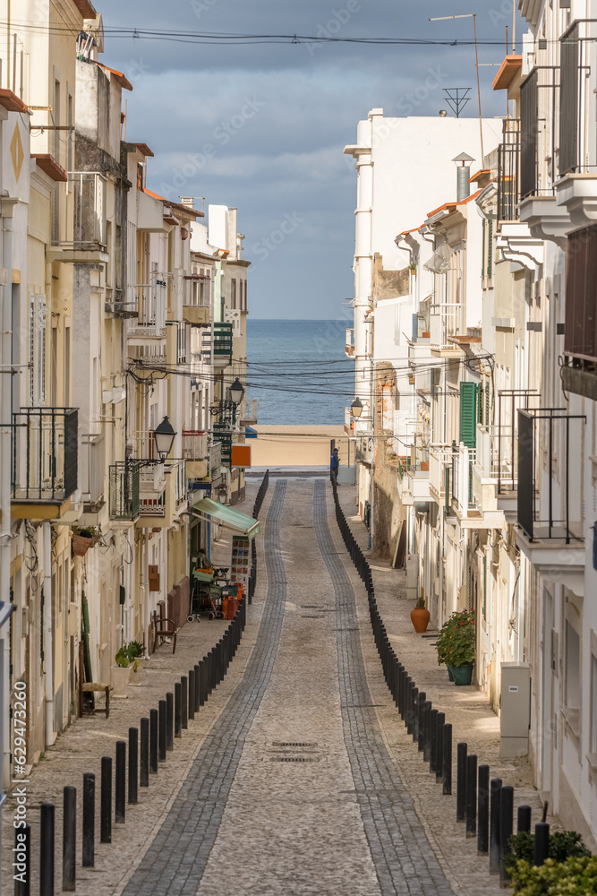 View of a narrow and empty street in Nazare , Portugal.
