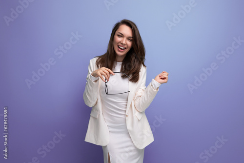 stylish young brunette woman in white dress shows her confidence and smile