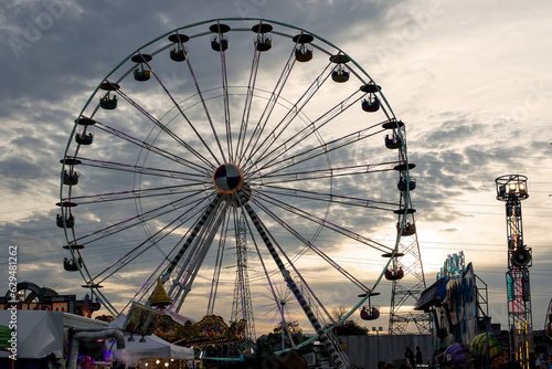 Ferris wheel and sunset sky at amusement park